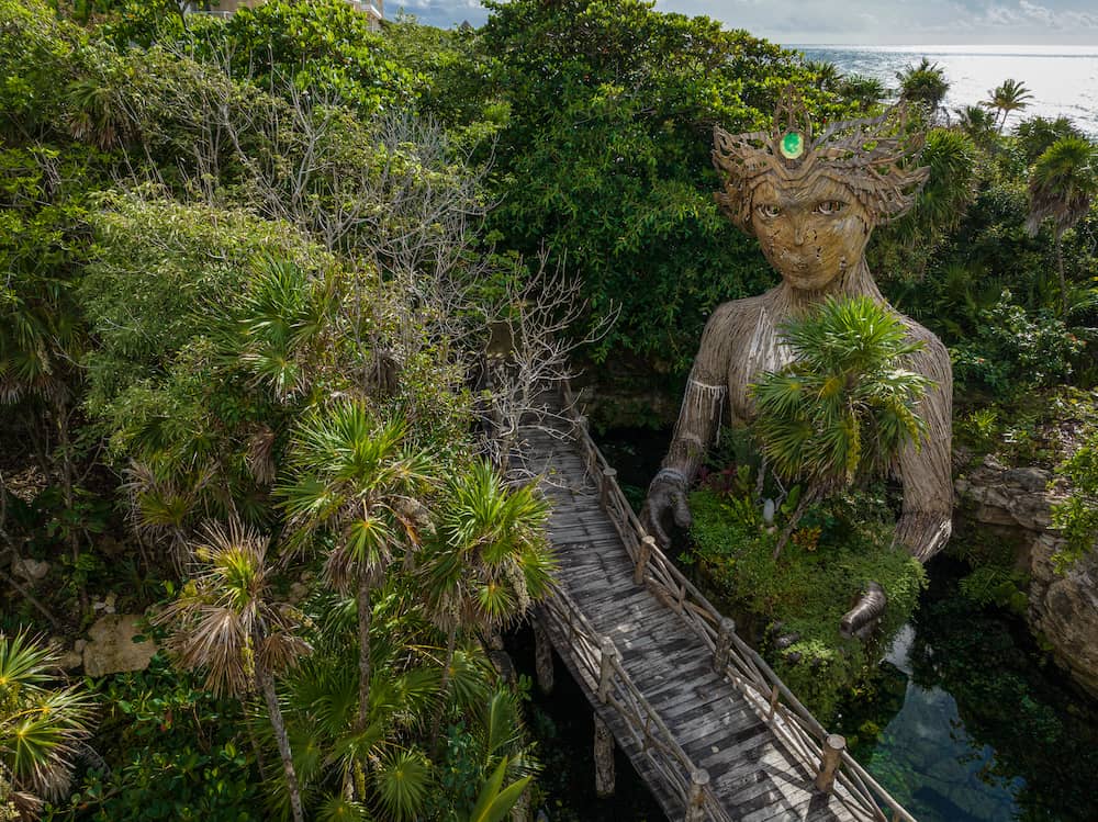 The guardian sculpture in Palmaïa's jungle, the Caribbean beyond